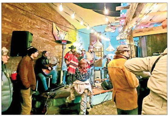 The Doodlin’ Hogwallops perform at Alpine’s Artwalk Saturday night on the Kiowa Hideout stage. Revelers braved the cold, wet weather to enjoy the live music. Avalanche photo by Kara Gerbert
