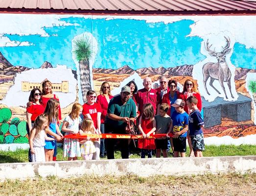 The Alpine Ambassadors were on hand on Saturday, August 29, to mark the official ribbon-cutting and dedication of Alpine’s newest mural. Painted on the side of the donut shop, just north of Alpine Elementary, mural artist Ramon Deanda was on hand with some of his young artists who helped him create the piece. Photo by Kara Gerbert