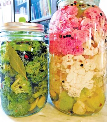 Broccoli fermenting with garlic, bay leaf, peppercorns, and red pepper flakes; and every color of cauliflower I could find with the same spices.
