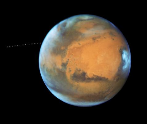 Mars and its orbiting moon Phobos as seen by the Hubble Telescope, which documented the moon’s orbit with time-lapse photography. Photo courtesy of NASA