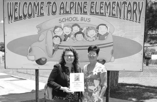Alpine city council member for Ward 1, Judy Stokes presented the Dark Skies coloring books created by the Alpine High School art students to AISD superintendent Michelle Rinehart last week for the Alpine Elementary School. Courtesy photo