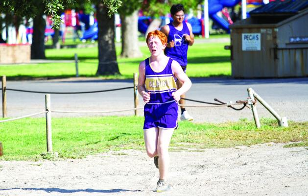 In his first cross-country meet as a new high school freshman, Ty Ritchie rounds the corner during the boys’ JV race at Pecos’ Maxey Park for the West of the Pecos race. Photo by Kara Gerbert
