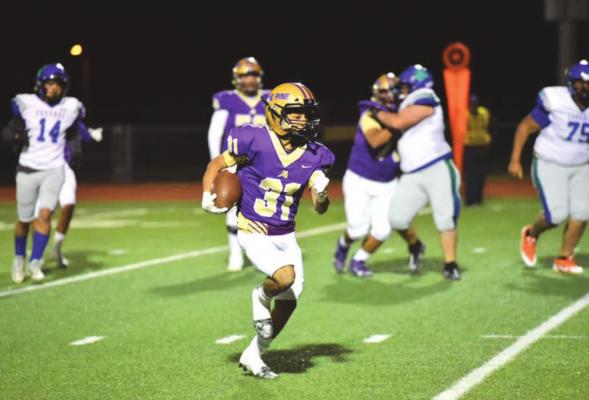 FightinÊ Buck Evren Martinez runs with the ball at Alpine High SchoolÊs homecoming game against the Odessa Compass Cougars on Oct. 29 at Buck Stadium. Photo by Felipe Fierro