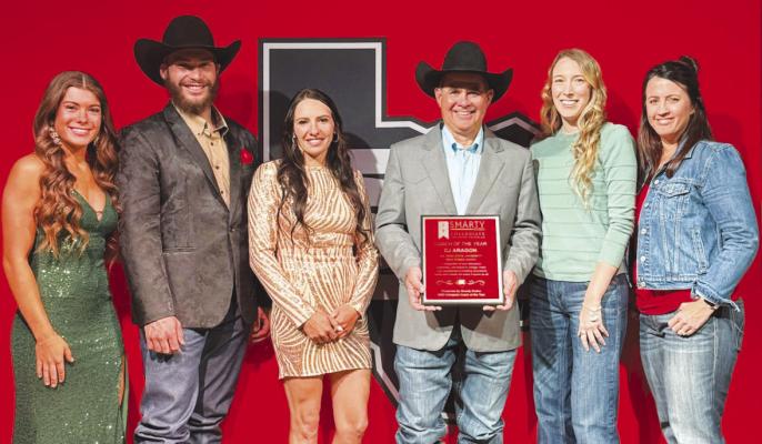 Coach C.J. Aragon is pictured with team members Rylee Sabelko, Camerson Haumea, Assistant Coach Timmi Hutchings, and representatives Abby Barnes and Amanda Shaffer who presented him with his newest award. Photo courtesy of Smarty Rodeo