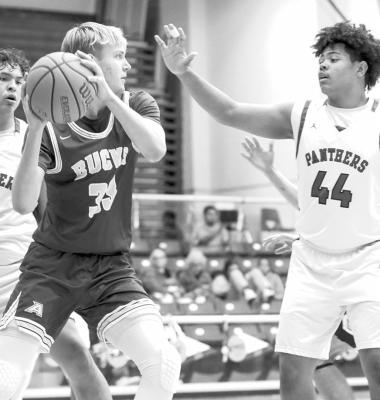 Zane Wash tries to find an open player during a game against Fort Stockton earlier in the season, as he is surrounded by two of the Panther defensemen. Photo by Shawn Yorks