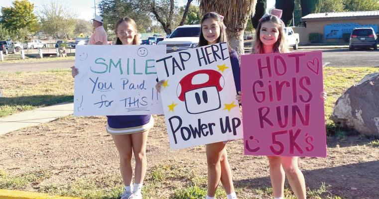 These Lady Bucks, Lucy Fraser, Athena Villanueva, and Layla Chavarria, volunteered their time and cheered on runners who participated in the Family Crisis Center of the Big Bend’s 1 Mile Closer to Hope 5K in honor of Domestic Violence Awareness Month. The run began at Sul Ross State University’s Zuzu Verk Amphitheater. Courtesy Photo