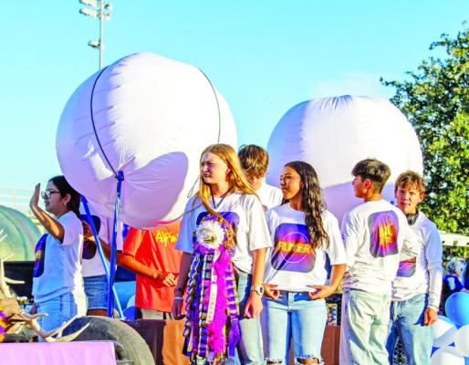 The cross-country teams weren’t going to be left out, as they climbed aboard a flatbed and represented the Runnin’ Bucks of Alpine during Wednesday’s homecoming parade and pep rally. Photo by Kara Gerbert
