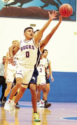 Evren Martinez, 0, reaches for the ball in this Dec. 17 file photo against El Paso Mountain View at the Fort Stockton tournament. Martinez suffered an injury over the Christmas break and missed about a month, but is now back in action at full speed, just in time for Alpine’s playoff run. Photo by Shawn Yorks