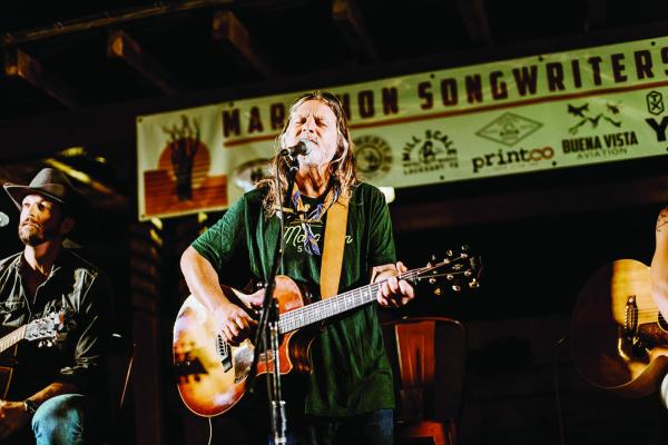 Walt Wilkins performs his soulful troubadour stylings for the crowd at the Gage Hotel, as Josh Grider looks on. Photo by Natalie Barrett