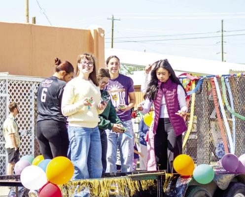While many throw candy to parade spectators, the Alpine High School Student Council, aboard their decorated trailer for Alpine’s Cinco de Mayo parade, threw popsicles to the kids waiting with bated breath to catch treats from the multiple floats and decorated vehicles. Photo by Kara Gerbert