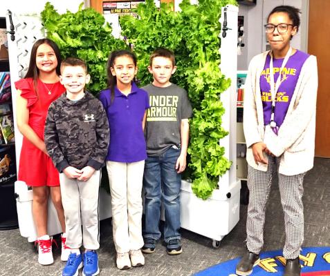 During last week’s meeting, students from Ms. Gordon’s fourth-grade science class presented the AISD board with lettuce from their hydroponic Flex Farm. From left are Misela Gonzalez, James Bell, Rebekah Solis, Grayson Vaughn, and Ms. Gordon. Photo by Kara Gerbert