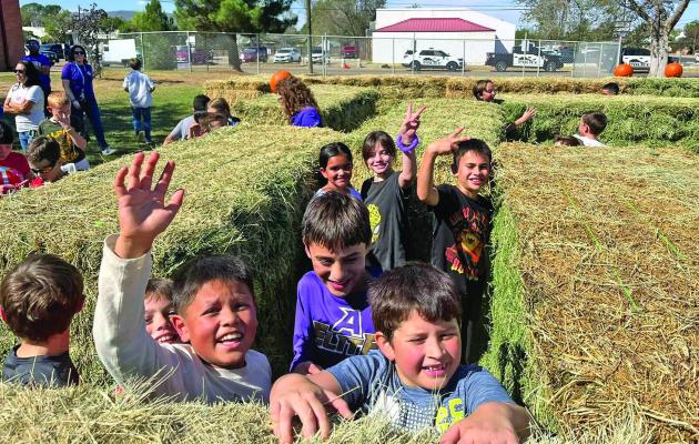 Despite a little afternoon rain last Thursday, the City of Alpine, Alpine Police Department, and Alpine Elementary School set up a hay bale maze at AES along with hundreds of pumpkins that each student was able to take home with them after they enjoyed their trip through the pumpkin patch and maze last Friday. Photo courtesy of Alpine Police Department