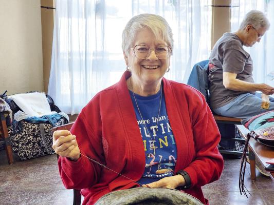 Robbie Burns, a member of the Desert Sky Quilters group is shown doing hand work on the binding of a large quilt she is making as a retirement gift. Burns is one of 17 active members of the quilting group which will hold their annual quilt show on March 18 at the Sunshine House. Avalanche photo by Kara Gerbert