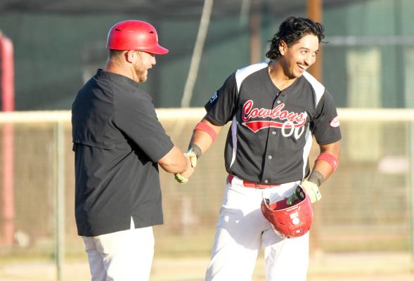 The Cowboys’Marco Martinez shakes hands with Cowboys’ manager Lance Myers in one of the team’s last battles at Kokernot Field this season. Photo by Julie Myers