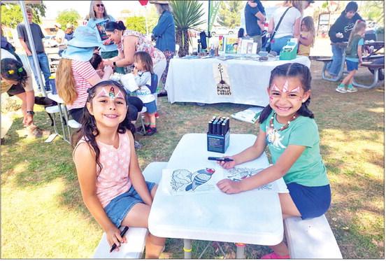 Zariah Griego and Olivia Chacon enjoy coloring bird pictures supplied by ABC Birds at Saturday’s 2025 Earth Day celebration held at the Alpine Visitor Center. Multiple booths were set up on the front lawn that focused on conservation, wildlife, and education. Photo by Kara Gerbert