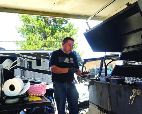 Porter’s Grocery brought their BBQ trailer to Fort Davis this past weekend to help the Fort Davis ISD’s National Honor Society. Samples of ribs and brisket from the competing cooks at the Tastes for Tips trailer could be purchased for a donation that benefits the school organization. Pictured is Trae Dutchover from Fort Davis and General Manager of the area Porter’s grocery stores. Photo by Kara Gerbert