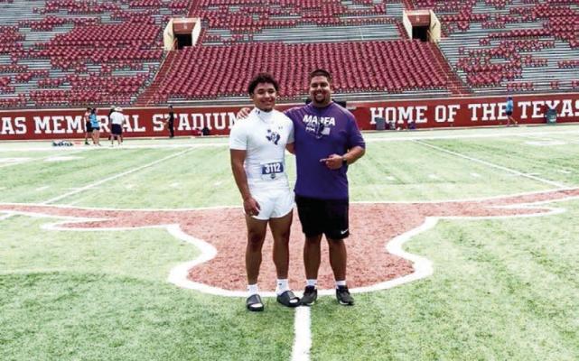 Marfa junior shot-put State qualifier Ayden Alvarez stands inside the Darrel K. Royal-Texas Memorial Stadium on the campus of UT Austin with his track coach, Kevin Pippen. Courtesy photo
