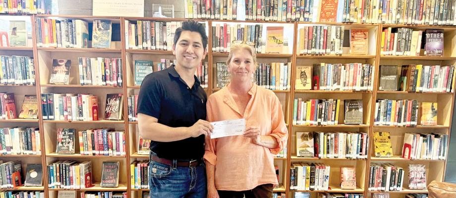 Executive Director of the Marathon Public Library Dara Cavness accepts a check from Isaac Pizzaro of TransPecos Banks in support of the library’s initiative to provide school supplies for Marathon ISD. Courtesy photo