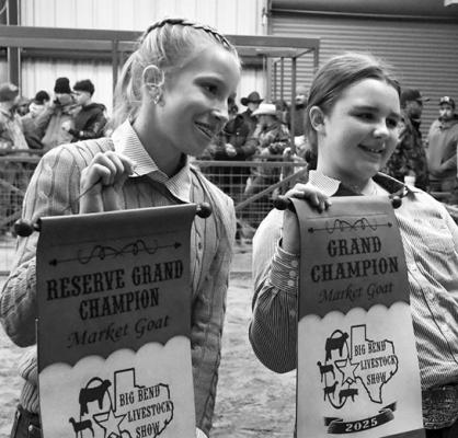 Kylie Maroney and Rynn Matthews pose for a photo with the banners they won for this year’s Grand Champion and Reserve Grand Champion market goats. Photo by Felipe Fierro