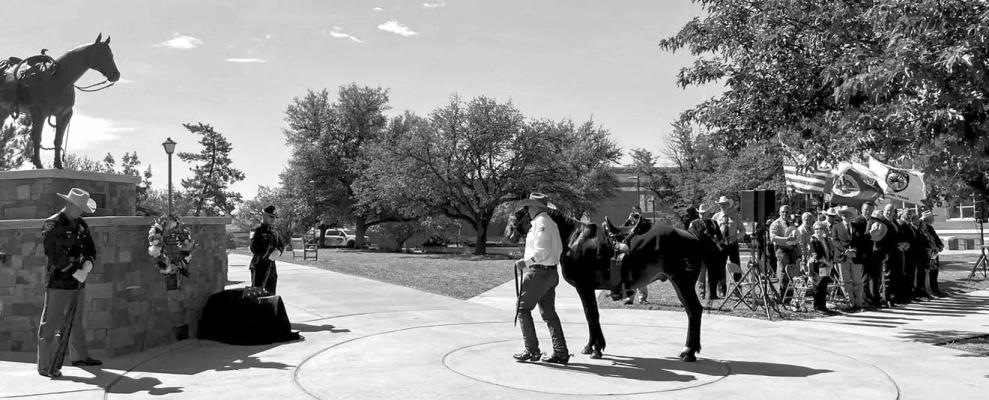 Area law enforcement gathered on the mall at Sul Ross State University last Wednesday for a memorial ceremony honoring law enforcement officers in the Big Bend area. Pictured are an officer of the Texas Department of Public Safety, an officer from the Odessa Police Department, and leading the horse, an officer with the Midland County Sheriff’s Office. Courtesy photo
