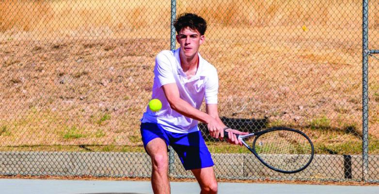 Alpine Buck Jack Juett carries a look of intensity as he attempts to return a volley during their district meet on Tuesday and Wednesday this week at Sul Ross. Courtesy photo
