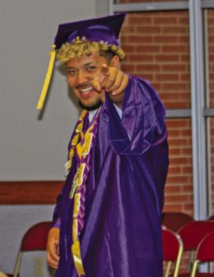 Always ready to ham it up for the camera, Alec Ramos catches the photographer snapping a shot as he and his fellow graduates prepare for their graduation ceremony last Friday night. Photo by Kara Gerbert