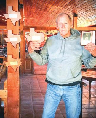 Prude Ranch General Manager Bruce Davis shows off this year’s WesTex Run n’ Gun winner plaques. Courtesy photo