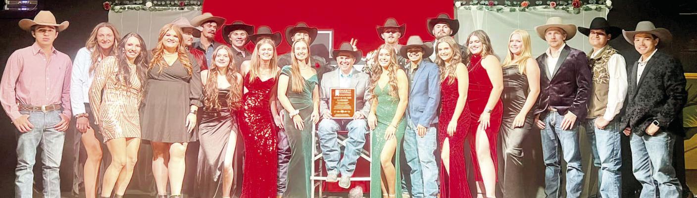 the Year. Photo courtesy of Amy Nunlee-Frank The Sul Ross Rodeo Team took time on Saturday night during their fundraiser to celebrate their coach, C. J. Aragon, after he received the Smarty Rodeo Collegiate Rodeo Program Coach of