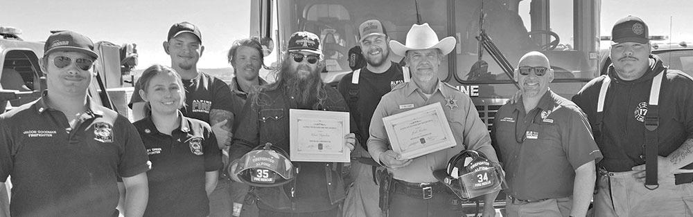 The Alpine Volunteer Fire Department members recently added Chris Stapleton and Josh Brolin to the AVFD as honorary firefighters due to their contributions to first responders. From left are Jacob Goodman, Shelby Green, Blake Marler, Zack Davis, Chris Stapleton, Kiddo Campbell, Josh Brolin, Chief James Etchison, and Jeremiah Pearce. Courtesy photo