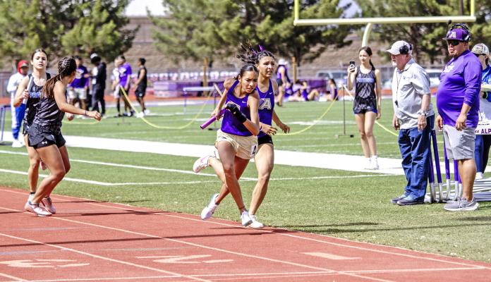 Junior Emy Hernandez takes the baton from Senior Hope Dominguez Saturday afternoon in the girls’ 4x400m relay at Buck Stadium. The Lady Buck team won the relay over teams from Presidio, Kermit, and Sanderson. Photo by Kara Gerbert