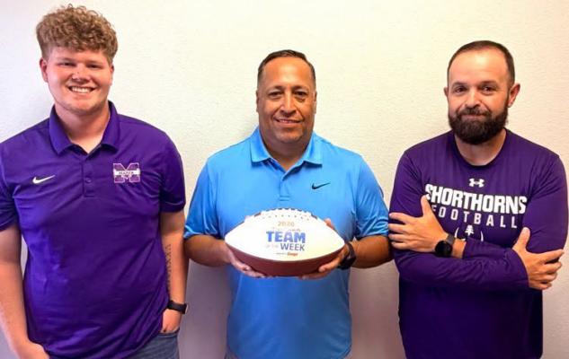 Marfa coaches Zachary Wilson, Felix Reyes, and Marcus Ortega pose with the Dave Campbell football honoring their recognition. Photo courtesy of Marfa ISD