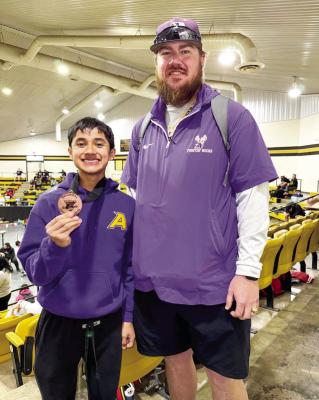Danny Santos participated in the boys’ regional powerlifting competition last week and earned a third-place finish and a medal. He is pictured here with powerlifting coach Jackson Yezak. Courtesy photo