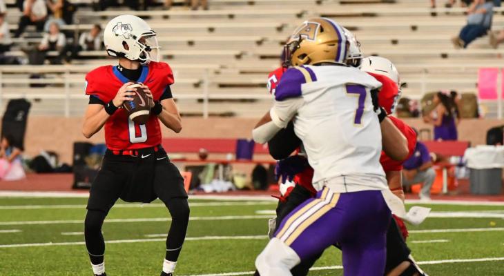 Coahoma’s Austin Joslin searches for an open receiver as Alpine’s Marcus Ramirez attempts to break through the Bulldogs’ offensive line. Courtesy Photo