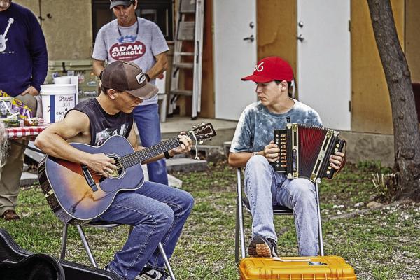 Everett and Davis Edwards take their turn during the First Friday Song Swap at Far West Guitars. Photo by Kara Gerbert