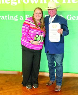 Child Nutrition Director Amanda Lujan is pictured here with Texas Agriculture Commissioner Sid Miller as he presents her with the Texas Department of Agriculture Farm Fresh Challenge certificate. Courtesy photo