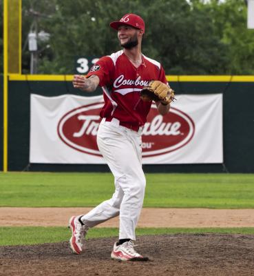 Cowboys pitcher Dieterich Guertzgen is all smiles after a successful play during the Cowboys’ matchup against Roswell. Photo by Julie Myers