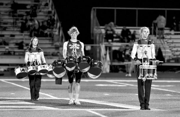 When he’s not kicking the football for an extra point, Walt Urbanczyk entertains football fans on the drums as a member of the Alpine Fightin’ Buck Band. Pictured are Sierra Ruckman on toms, Urbanczyk on toms, and Hatfi eld Cason on snare drum.