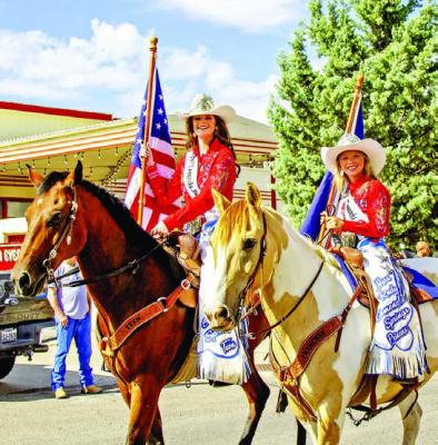 Miss Comanche Springs Teen, Kendall McComb, and Comanche Springs Princess, Sadie Wood carry the Stars and Stripes and the Texas state flag during Alpine’s Independence Day parade.