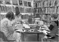 Cole Torres, Bobbie Gallo-Trehus, and Ellis Adams work on craft projects at the Marathon Public Library. Courtesy photo