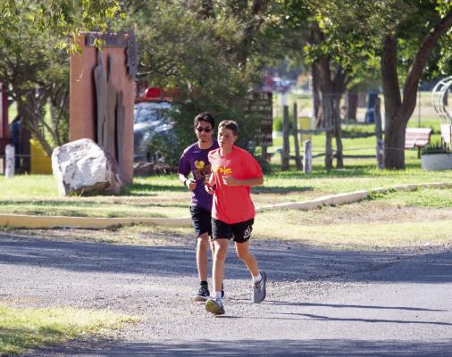 Putting in the miles before the first day of school on Tuesday, freshman Barry Young and senior Raul Renteria come up Fighting Buck Avenue to Kokernot Park, where their five-mile run ends. Photo by Kara Gerbert