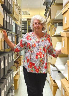 Senior Archivist Melleta Bell, now retired, stands among the collection at Archives of the Big Bend. Avalanche photo by J.T. Maroney