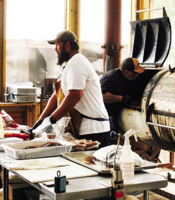 Phillip Moellering from the Gage and the Brick Vault is hard at it, working with fellow pitmasters at Blackboard BBQ in Sisterdale to help feed first responders and flood victims. Courtesy photo