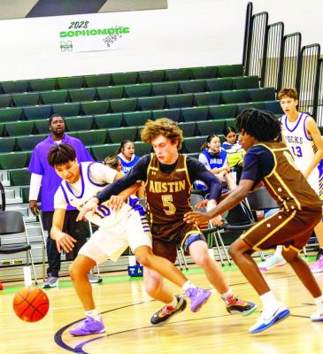 Thaddeus Prieto battles to keep control of the ball and keep it away from El Paso Austin’s Carson Collins. Photo by Kara Gerbert