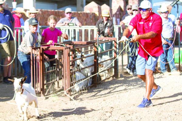Sul Ross ANRS alumni board member Aaron Cruz catches a goat during Friday night’s kick-off celebration for the SRSU ANRS Exes Reunion. Photo by Kara Gerbert