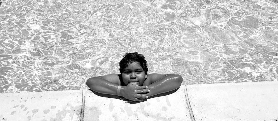 Oren Galindo takes a break from frolicking in the water at the Alpine city pool. Galindo, along with numerous other kids and adults, are taking advantage of the cool water during the hot afternoons. Photo by Kara Gerbert
