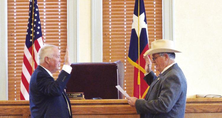 Newly elected Brewster County Judge Greg Henington is being sworn in by Sheriff Ronny Dodson on Jan. 1. Henington was one of seven county officials sworn into office on New Years day. Photo by Kara Gerbert