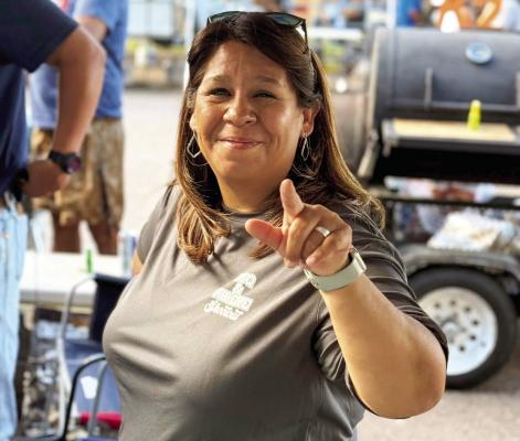 Stephanie Rubio, one of the creators of the Smoke in the Mountains BBQ and Ribeye Shootout, tells us how it is at this past weekend’s fundraising cook-off. Photo by Carolyn Nored Miller
