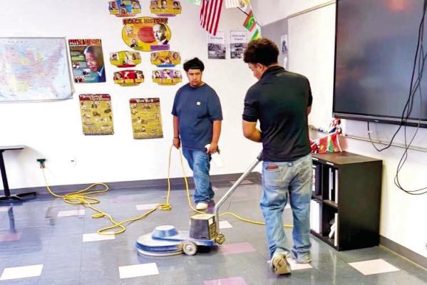 These Marfa ISD students are working on classroom fl oors as part of their summer internship program to get the school ready for the new school year. Photo courtesy of Marfa ISD