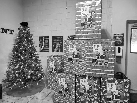 Boxes located at the Alpine Police Department sit ready to be filled with unwrapped gifts for less fortunate children.