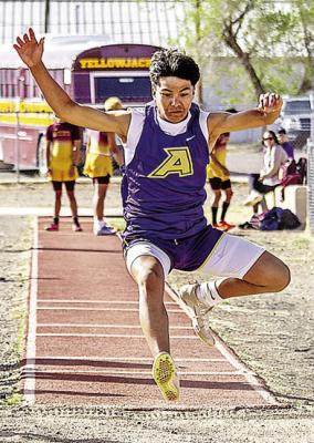 Thaddeus Prieto hovers above the sand just before landing during the boys’ long jump competition at last Thursday’s District track meet. Photo by Kara Gerbert